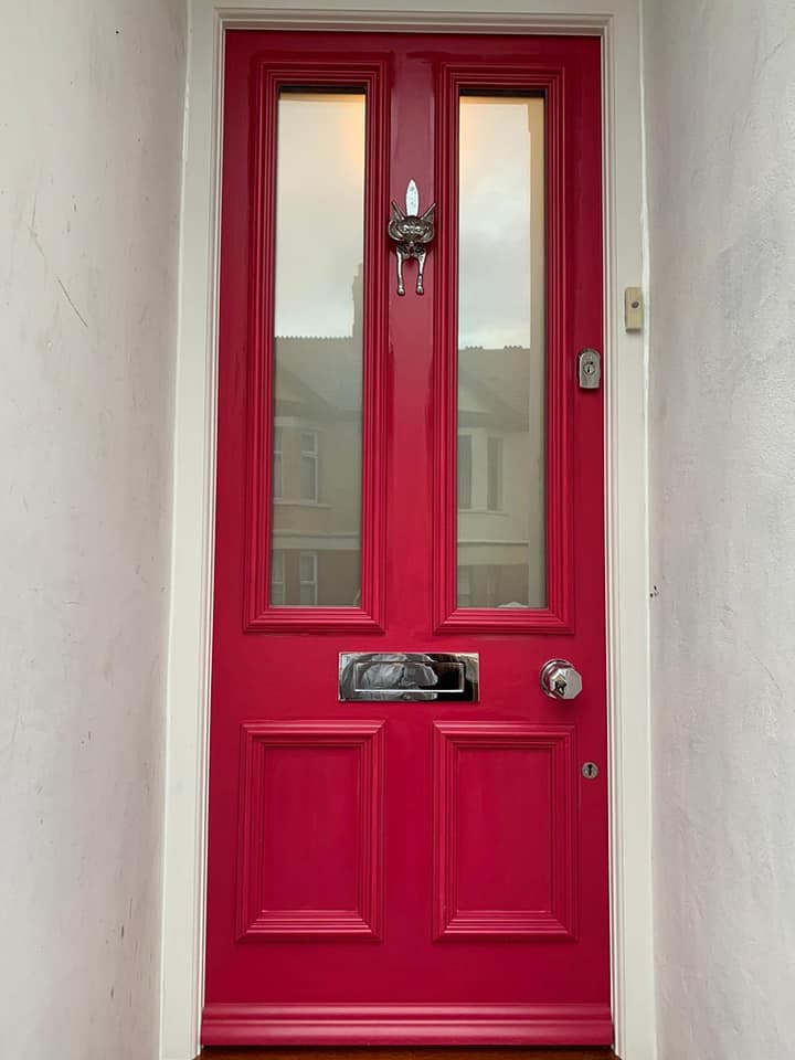Victorian door after restoration - vibrant red with restored features