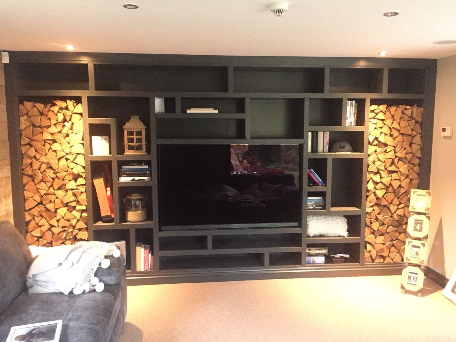 Bespoke entertainment unit with integrated log storage and shelving